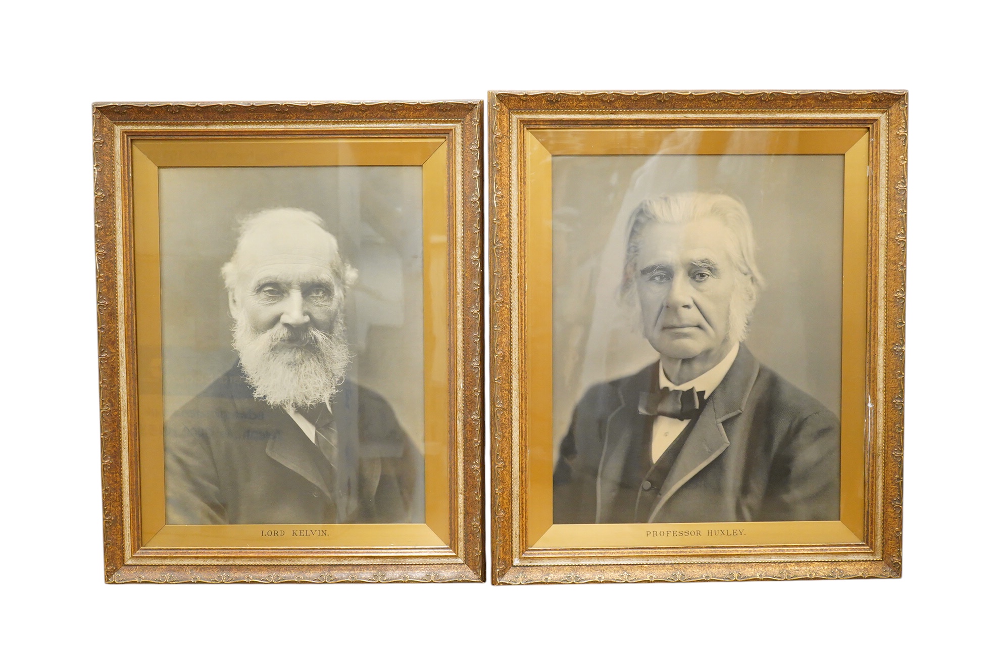 A pair of black and white photographs of Professor Huckley and Lord Kelvin, framed